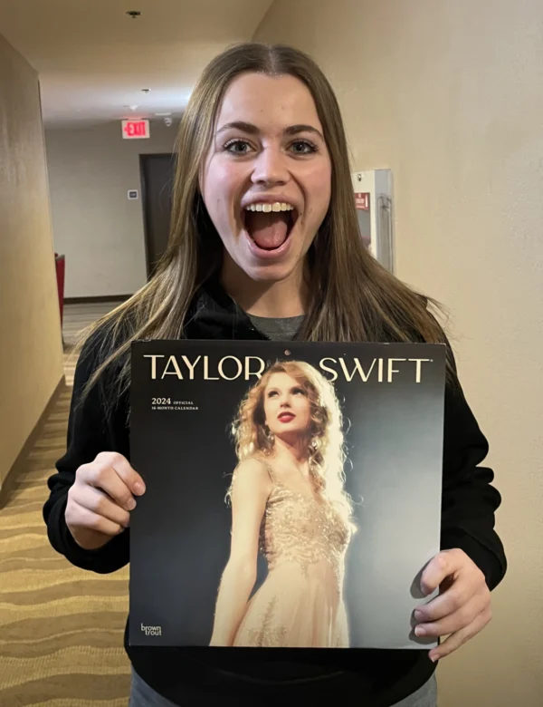 Kirsten Beagley, excitedly holding up a Taylor Swift record.