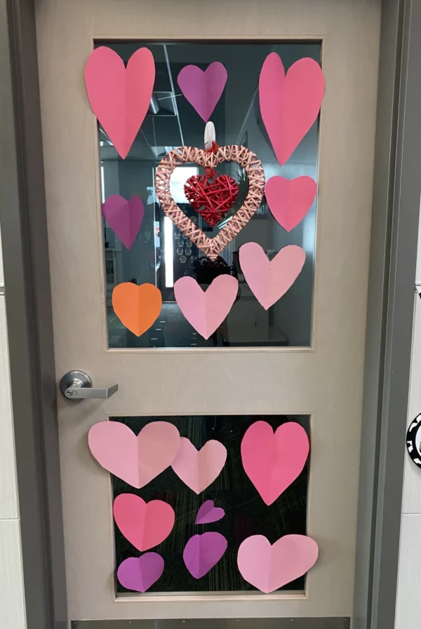 A door to a classroom at Bryce Valley Elementary School covered in pink hearts.