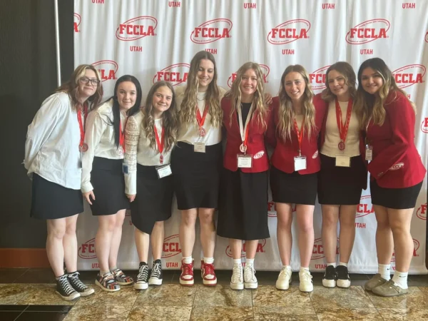 Eight girls dressed in white, red, and black at state FCCLA