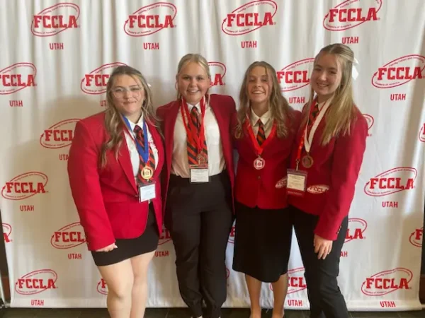Four girls dressed up nice wearing red and black at FCCLA.