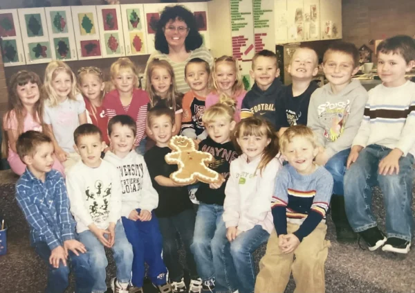 MarJean Davis with her kindergarteners and their gingerbread cookie.