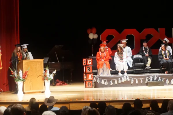 Ryen and Korben at the podium speaking at Escalante's graduation.