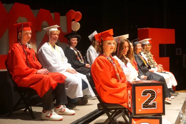 Escalante's eleven graduates seated on stage at their graduation.