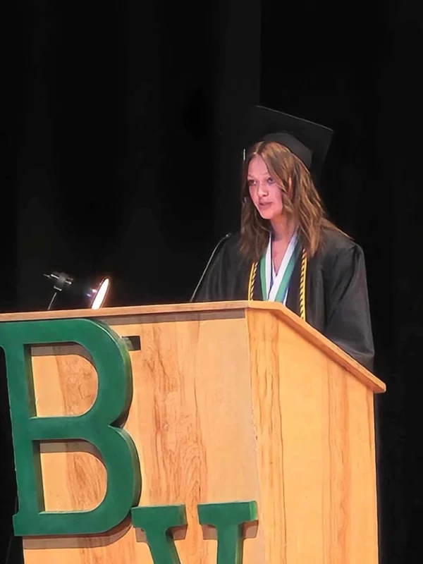 Bradi Gates speaking at the "BV" podium at Bryce Valley's graduation.