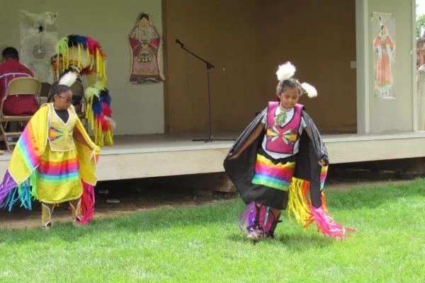Piute girls dressed in traditional attire perform a dance at the Escalante Showhouse.