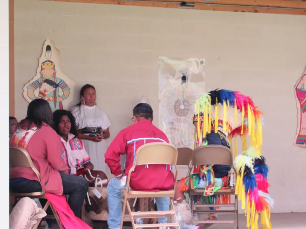 Piute boys and men dressed in traditional attire drum with the dancers at the Escalante Showhouse.