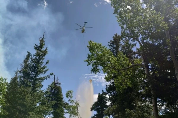 A helicopter drops water on the Little Twist Fire in Fishlake National Forest.