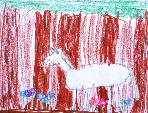 A kid's crayon and pencil drawing of a white unicorn surrounded by trees and flowers.