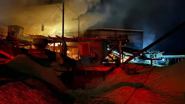 Fire contained inside the Panguitch sawmill. It is dark out, with red light showing on the scene.