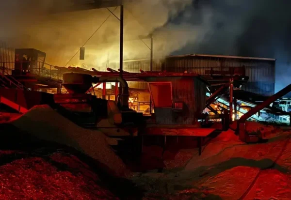 Fire contained inside the Panguitch sawmill. It is dark out, with red light showing on the scene.