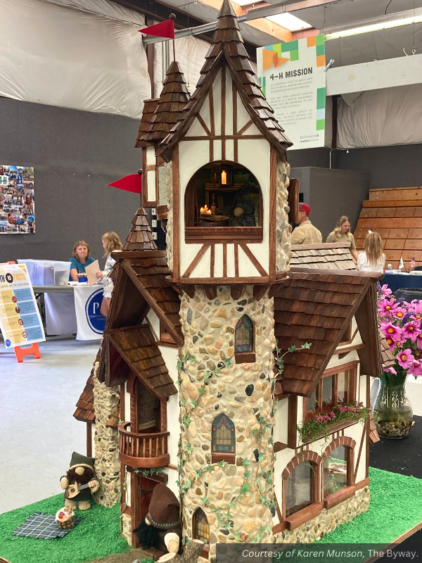 The tallest tower on the gnome home, with a grouted rock wall. A little LED light and fire can be seen through the window, with a gnome working inside.