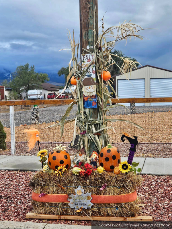 Polka-dot painted pumpkins sit on top of hay bales, along with sunflowers, corn stalks, a scarecrow, and other fall decorations. Courtesy of Circleville Town/Facebook.