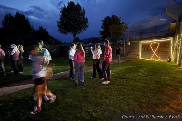 Gold lights and students throwing chalk at each other at Bryce Valley's baseball field. Courtesy of Eli Beesley, BVHS.