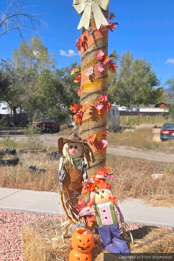 Scarecrows sitting on hay bales decorating a light pole in Circleville. Courtesy of Kristi Westwood.