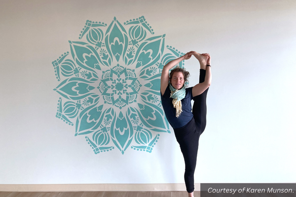 Becka Winkleman standing on one foot with her other leg above her head in her new yoga studio. Courtesy of Karen Munson.