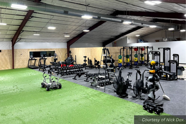 A large, high-ceilinged room full of work-out equipment. Courtesy of Nick Dax.