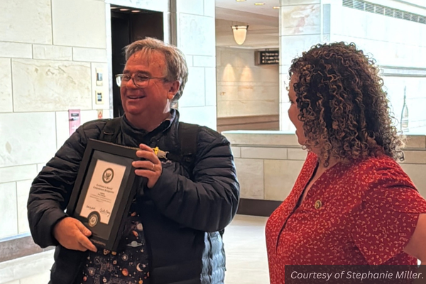 Pete Peterson with his congressional award. Celeste Maloy stands by. Courtesy of Stephanie Miller.