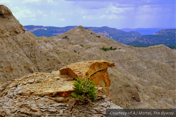 A cloudy sky over sandy white mountains in Southern Utah. Courtesy of AJ Martel.