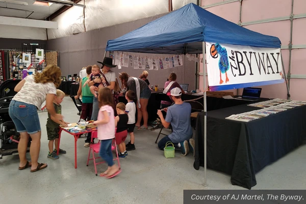 Youth work a booth for The Byway newspaper at the Garfield County Fair. Courtesy of AJ Martel, The Byway.