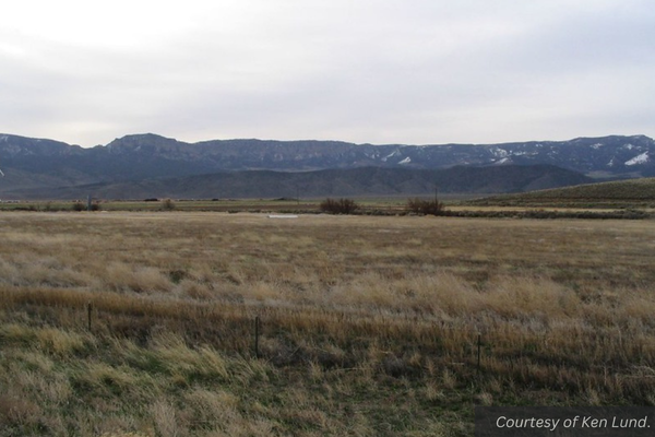 A grassy field with rounded mountains in the distance, just outside Circleville, Utah. Courtesy of Ken Lund.