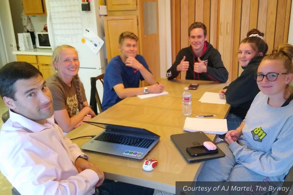 Five youth in a meeting with AJ Martel at a kitchen table. Courtesy of AJ Martel, The Byway.